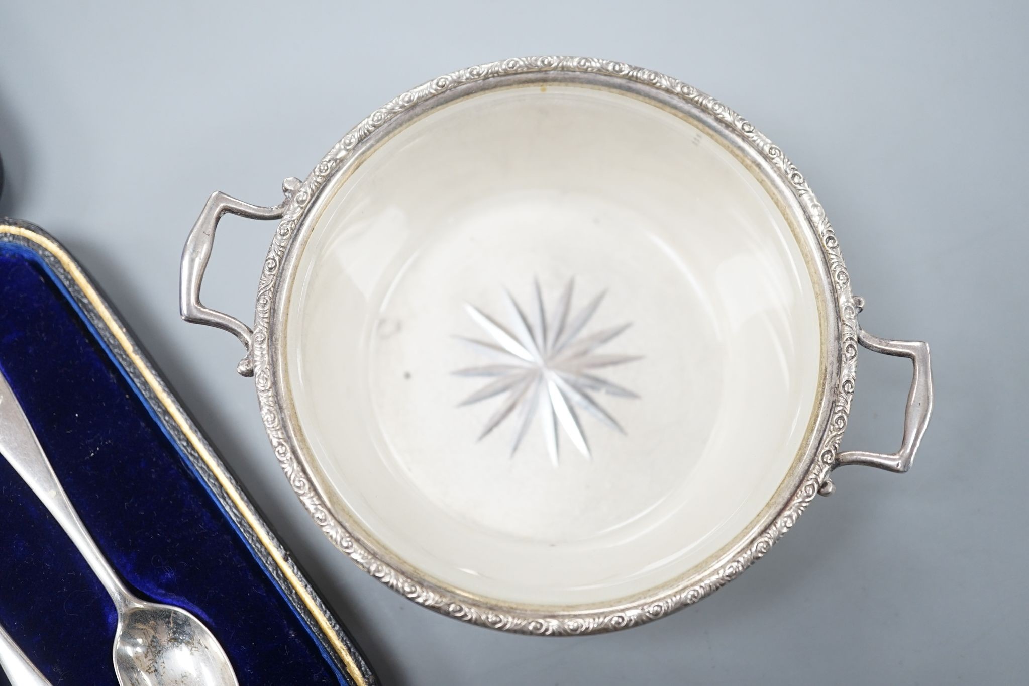 A set of six silver teaspoons, a silver two handled small butter dish, with glass liner and silver mounted cut glass toilet jar.